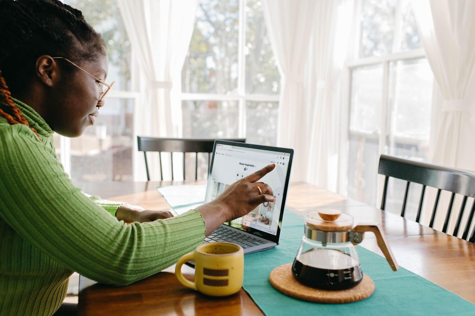 A woman working on her laptop drinking coffee